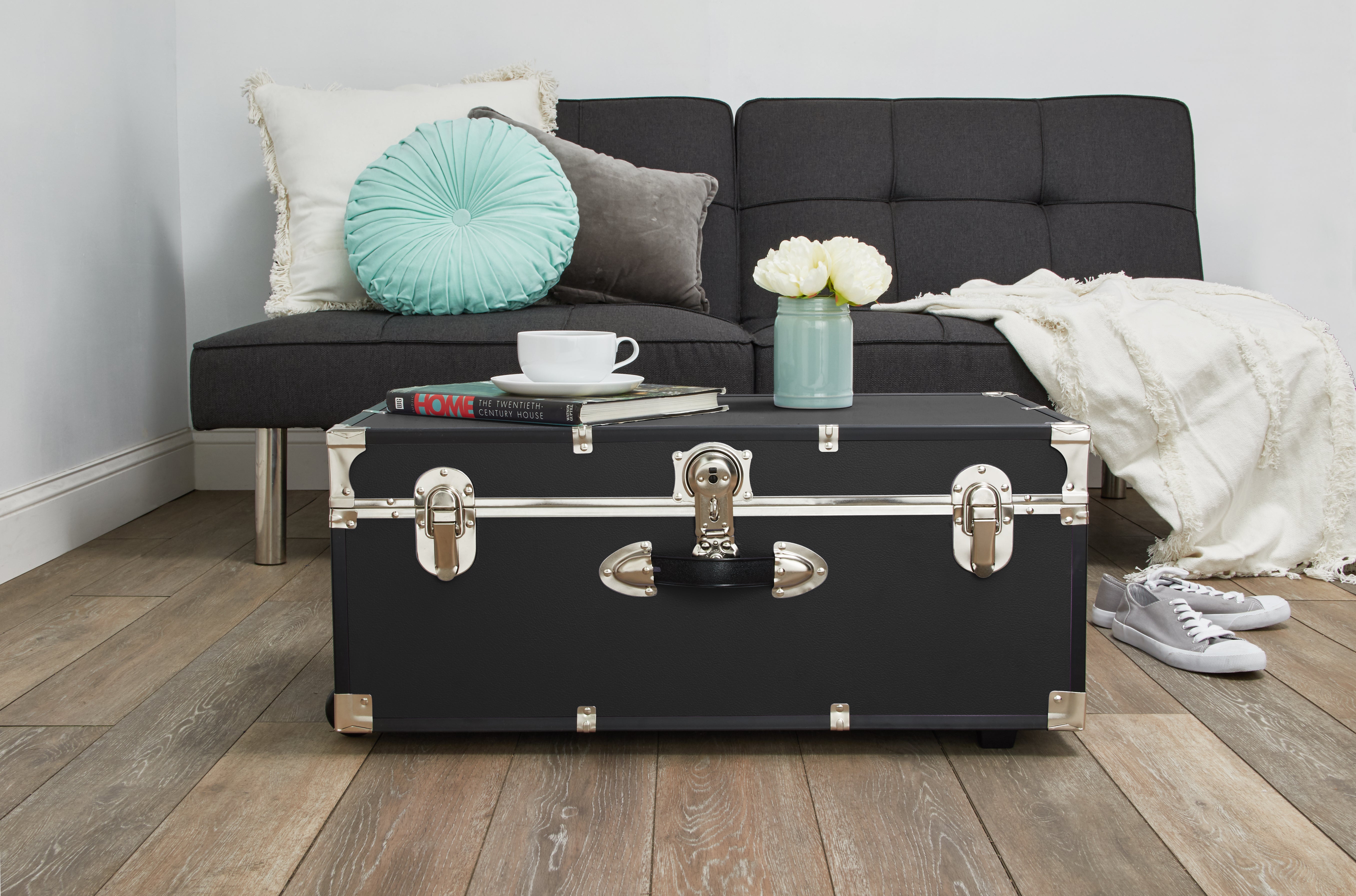 Trunk being used as coffee table, with teacup and flowers on top, in the living room - Seward Rover 30" Trunk with Wheels & Lock, Black